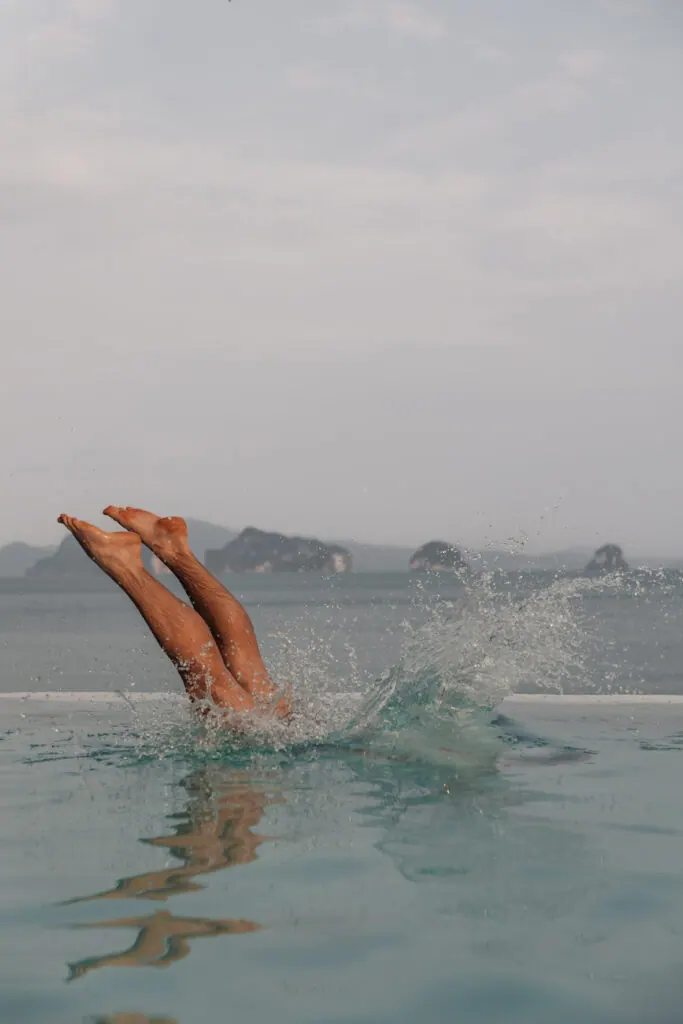 Legs diving into the infinity pool at Koyao Island Resort