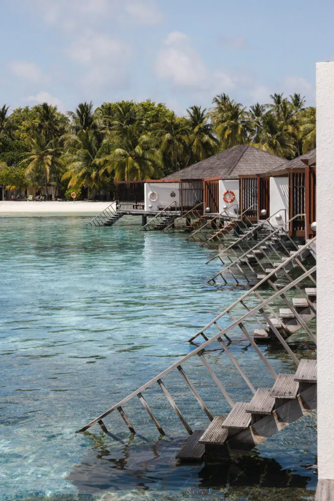 Overwater villas above the turquoise lagoon at Villa Nautica, Maldives